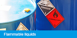 Flammable liquids elearning - drums of chemicals showing warning corrosive and flammable labels